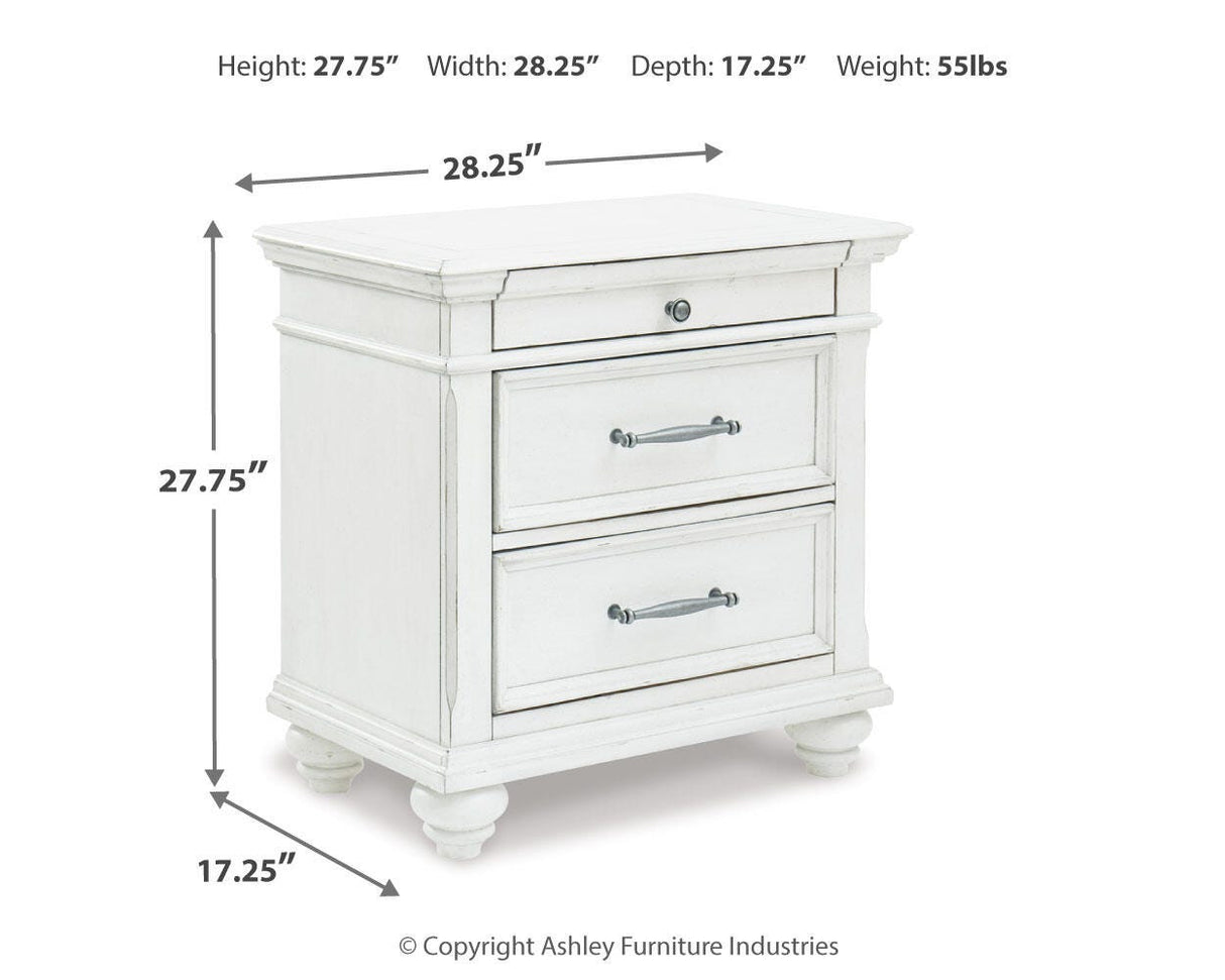 Kanwyn King Panel Bed with Mirrored Dresser, Chest and 2 Nightstands in Whitewash from Ashley - Luna Furniture