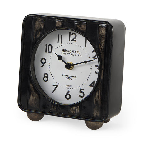 Karl 6.0L x 3.0W x 6.8H Rustic Black Iron Rounded Square Table Clock from Mercana - Luna Furniture