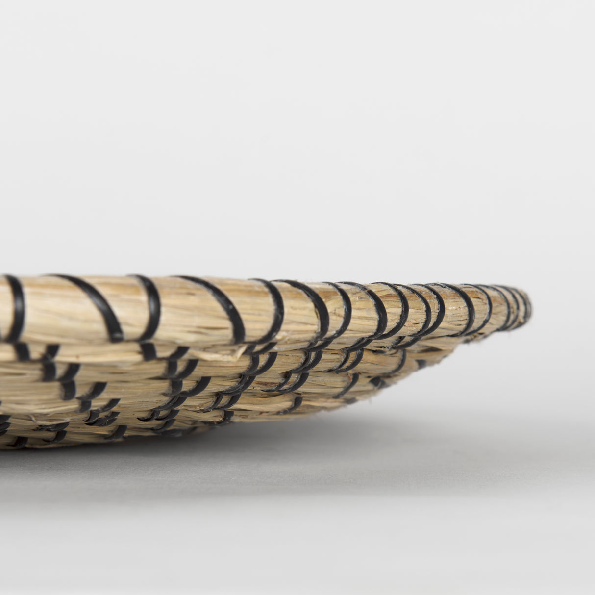 Mekhi 24.0L x 24.0W x 3.5 Light Brown Seagrass W/Black String Round Wall Hanging Plate from Mercana - Luna Furniture
