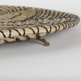 Mekhi 24.0L x 24.0W x 3.5 Light Brown Seagrass W/Black String Round Wall Hanging Plate from Mercana - Luna Furniture