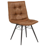 Aiken Saddle dining side chair, front three-quarter view, saddle-brown faux leather and black metal legs