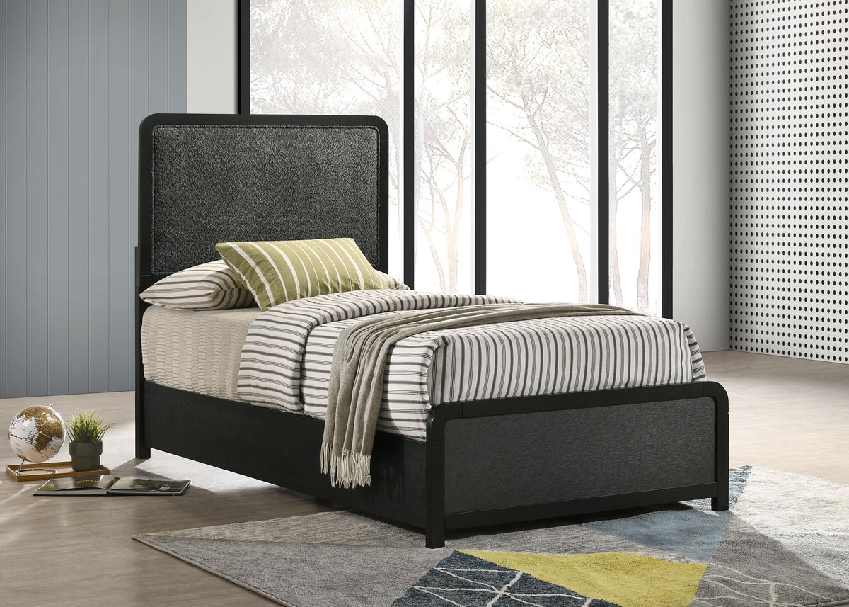 Cavelle Black Twin Panel Bed in styled bedroom, upholstered headboard and footboard