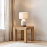Butte Natural square mango wood end table, natural finish, styled front three-quarter view