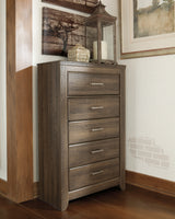 Juararo California King Panel Bed with Mirrored Dresser, Chest and Nightstand in Dark Brown from Ashley - Luna Furniture