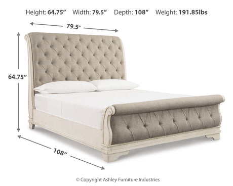 Realyn Chipped White California King Upholstered Sleigh Bed from Ashley - Luna Furniture