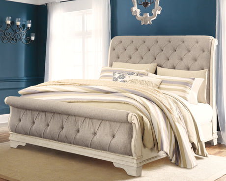 Realyn Chipped White Queen Upholstered Sleigh Bed from Ashley - Luna Furniture