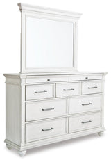 Kanwyn King Panel Bed with Mirrored Dresser, Chest and 2 Nightstands in Whitewash from Ashley - Luna Furniture