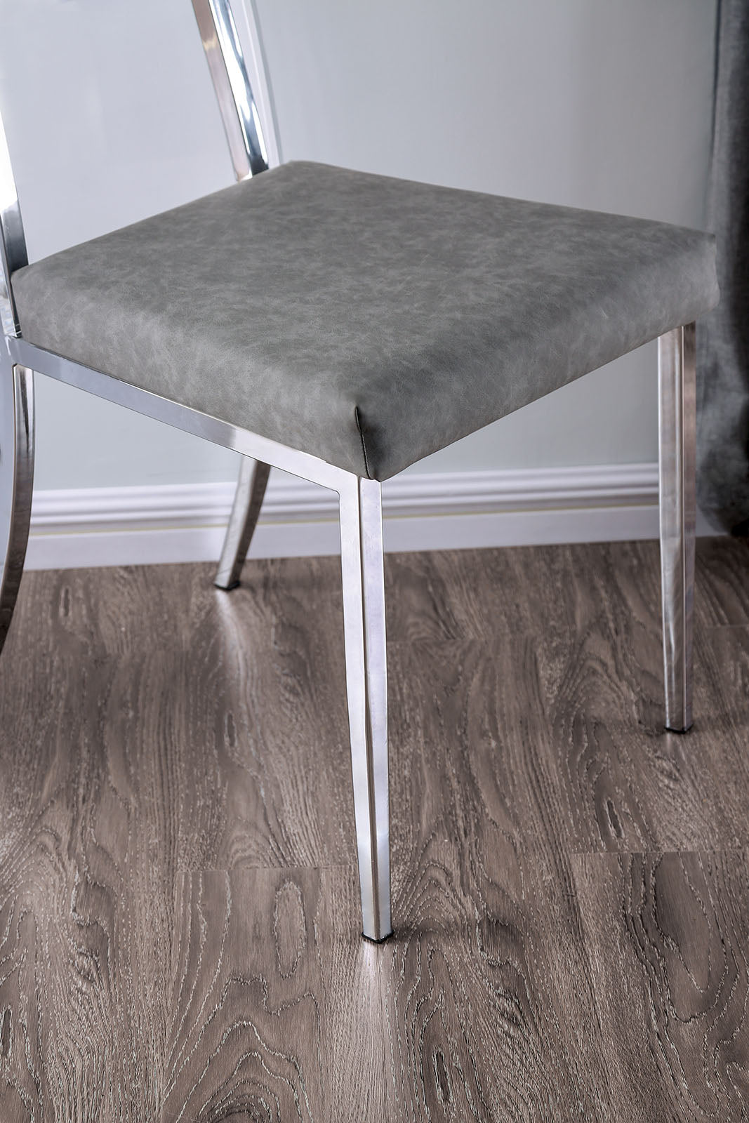 Casper Chrome dining chair, gray upholstered seat and chrome legs, side angle