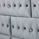 Stefania Gray bed frame detail, tufted gray upholstered side rails and footboard, angled view