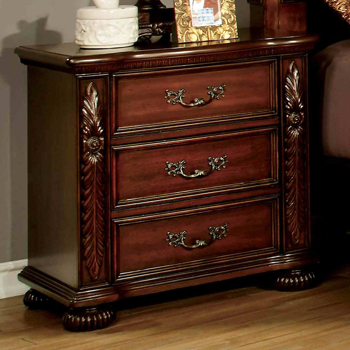 Flandreau Brown three-drawer nightstand, carved sides and antique pulls, front view