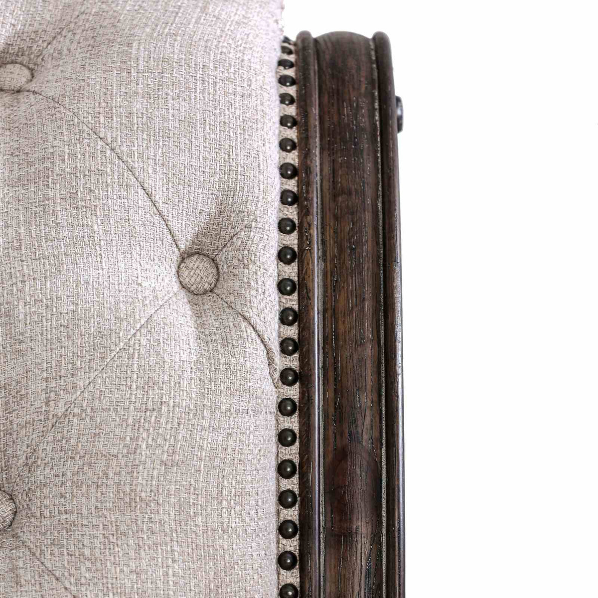Lysandra Rustic queen bed close-up, beige button tufting and dark wood side trim