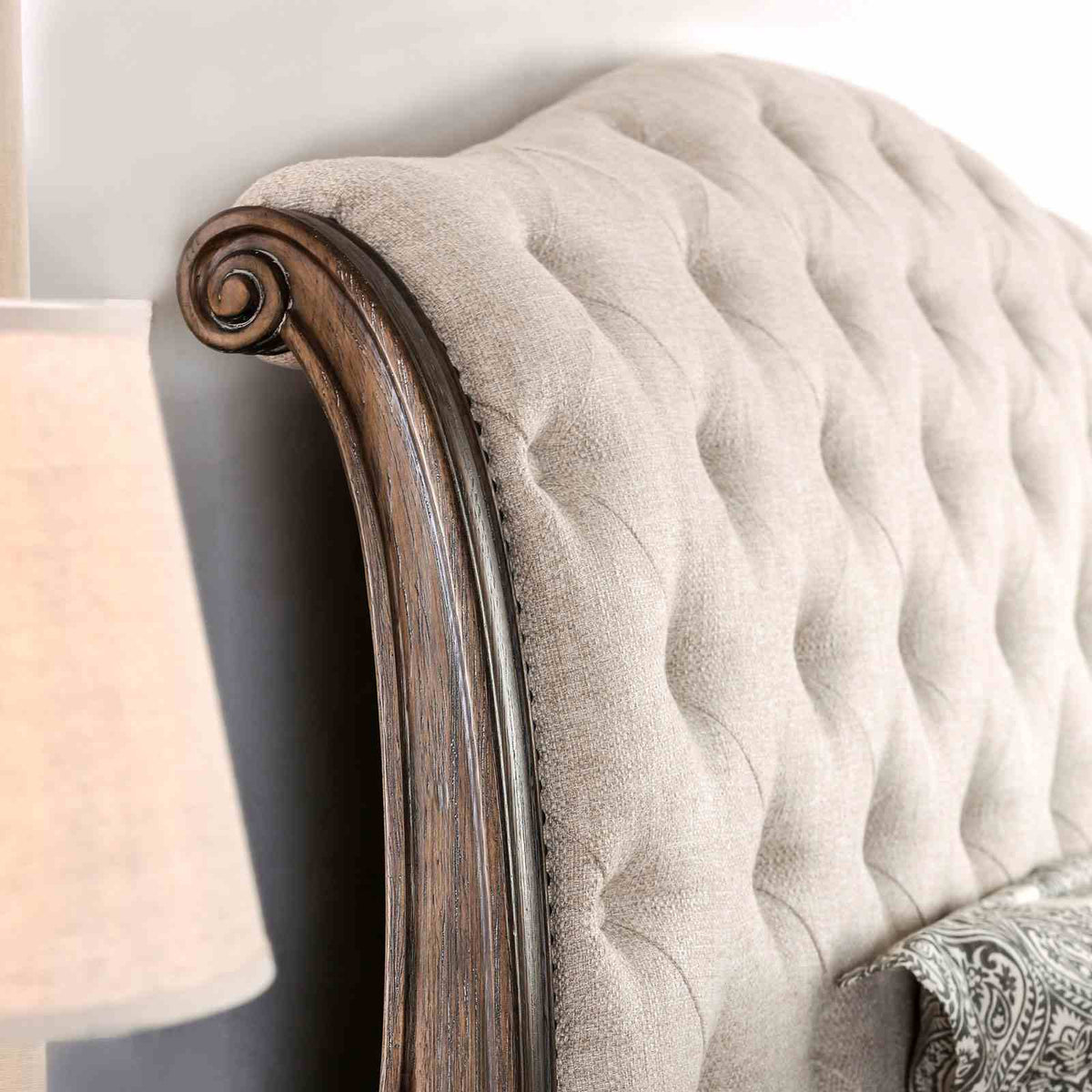 Lysandra Rustic bed headboard detail, tufted beige upholstery and curved wood frame