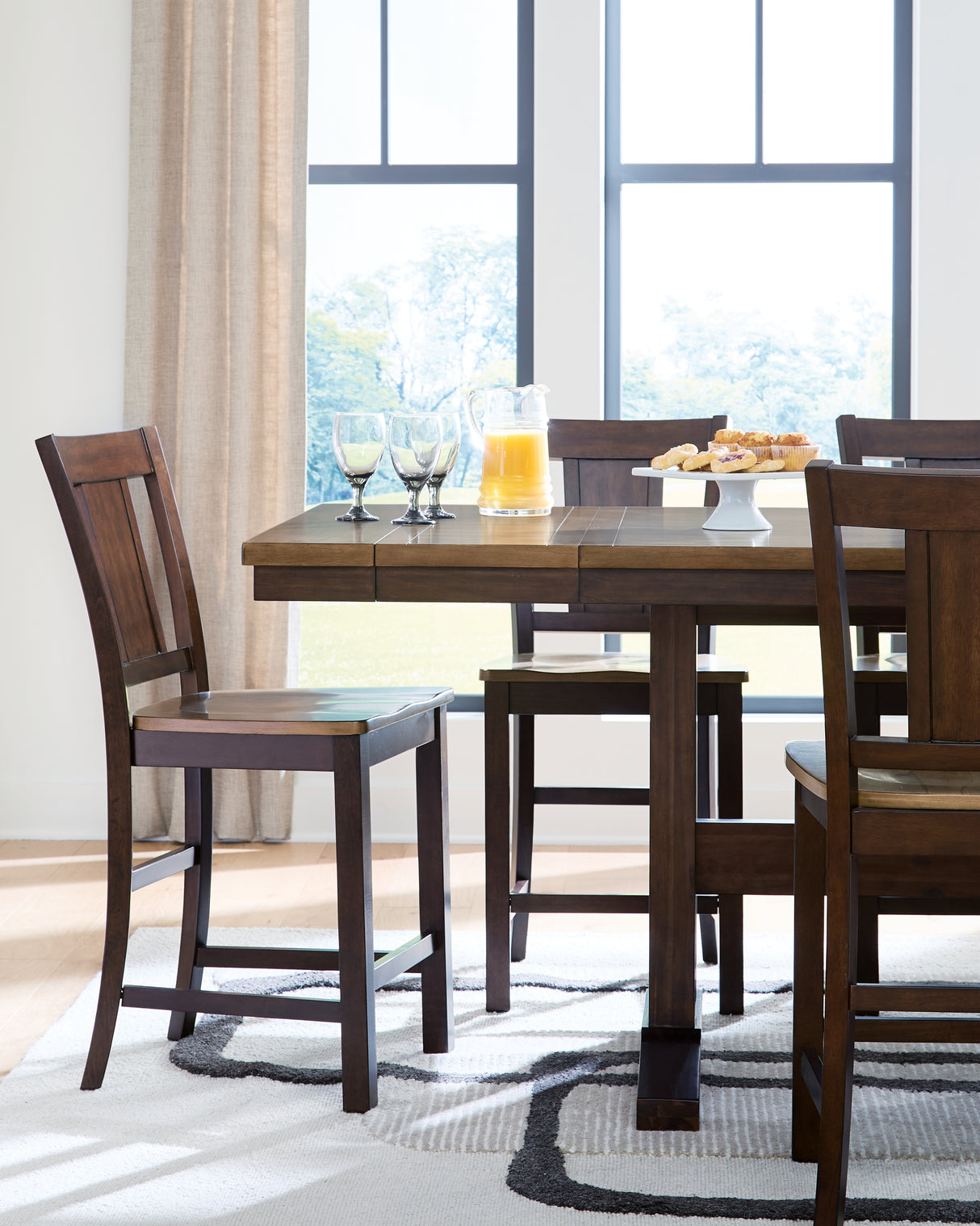 Rylandeen Light Brown/Dark Brown Counter Height Extension Dining Table and 4 Barstools from Ashley - Luna Furniture