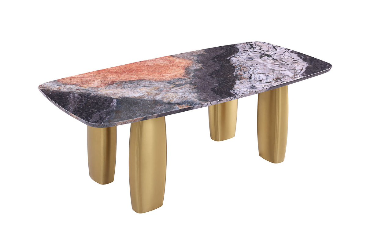 Contemporary dining table, multicolor stone-look top, matte gold legs, three-quarter view