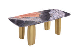 Contemporary dining table, multicolor stone-look top, matte gold legs, three-quarter view