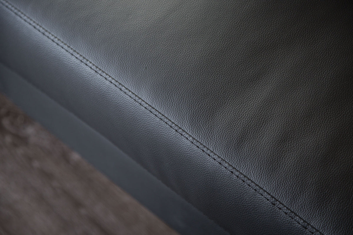 Stordal Black Sectional, close-up of black leather match upholstery and stitching, detail view