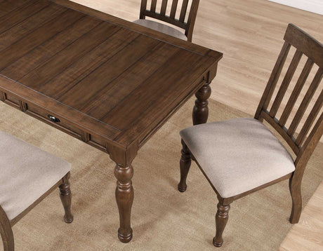 Joanna 59.5″ 4-Drawer Dining Table, Brown from Steve Silver - Luna Furniture