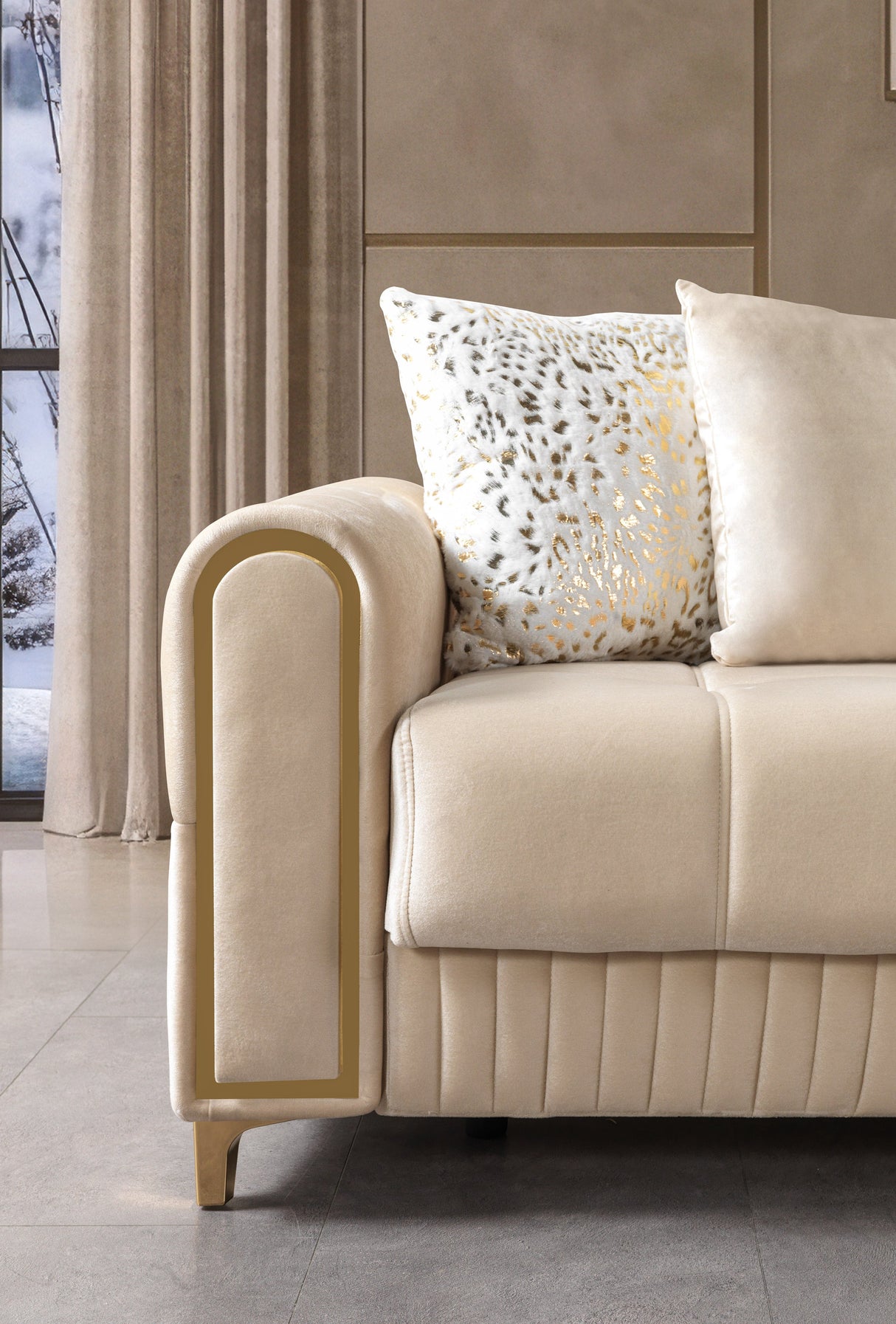 Sandra Ivory Velvet Convertible Sofa, close-up of gold-trim arm and patterned pillow