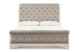 Realyn Chipped White King Upholstered Sleigh Bed from Ashley - Luna Furniture