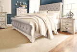 Realyn Chipped White King Upholstered Sleigh Bed from Ashley - Luna Furniture