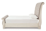 Realyn Chipped White Queen Upholstered Sleigh Bed from Ashley - Luna Furniture