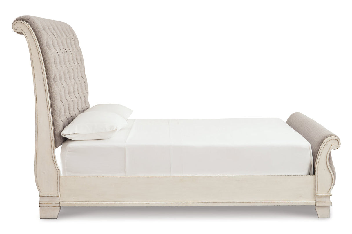Realyn Chipped White Queen Upholstered Sleigh Bed from Ashley - Luna Furniture