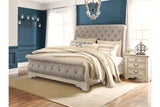 Realyn Chipped White Queen Upholstered Sleigh Bed from Ashley - Luna Furniture