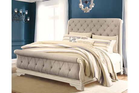 Realyn Chipped White California King Upholstered Sleigh Bed from Ashley - Luna Furniture