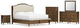 Sturlayne King Upholstered Panel Bed with Mirrored Dresser, Chest and Nightstand in Brown from Ashley - Luna Furniture