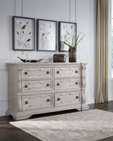 Bruchandi California King Upholstered Panel Bed with Dresser and Chest in Antique White from Ashley Furniture - Luna Furniture