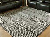 Kurtmen Black/Ivory Large Rug from Ashley Furniture - Luna Furniture