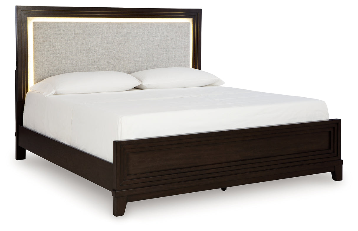 Neymorton King Upholstered Panel Bed with Mirrored Dresser and Chest in Dark Grayish Brown from Ashley - Luna Furniture