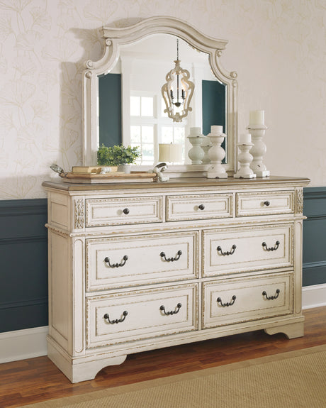 Realyn Chipped White California King Upholstered Panel Bed with Mirrored Dresser and Chest from Ashley Furniture - Luna Furniture