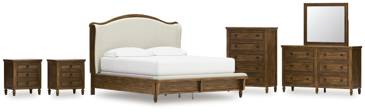 Sturlayne California King Upholstered Panel Bed with Mirrored Dresser, Chest and 2 Nightstands in Brown from Ashley - Luna Furniture