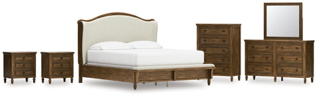 Sturlayne California King Upholstered Panel Bed with Mirrored Dresser, Chest and 2 Nightstands in Brown from Ashley - Luna Furniture