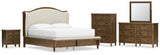 Sturlayne California King Upholstered Panel Bed with Mirrored Dresser, Chest and Nightstand in Brown from Ashley - Luna Furniture