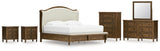 Sturlayne King Upholstered Panel Bed with Mirrored Dresser, Chest and 2 Nightstands in Brown from Ashley - Luna Furniture