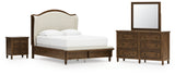 Sturlayne Queen Upholstered Panel Bed with Mirrored Dresser and Nightstand in Brown from Ashley - Luna Furniture