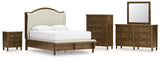 Sturlayne Queen Upholstered Panel Bed with Mirrored Dresser, Chest and Nightstand in Brown from Ashley - Luna Furniture