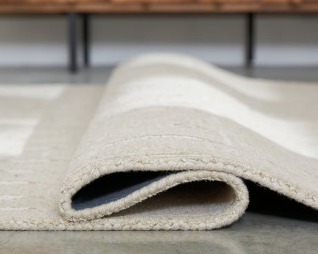 Wolbert Tan/Ivory Large Rug from Ashley - Luna Furniture